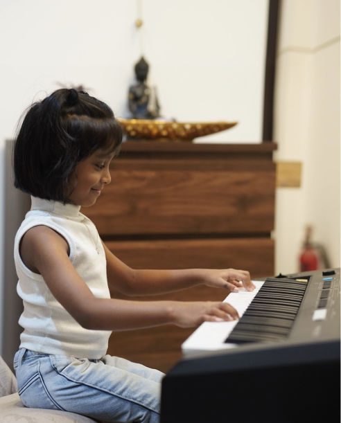 Student smiling at the keyboard