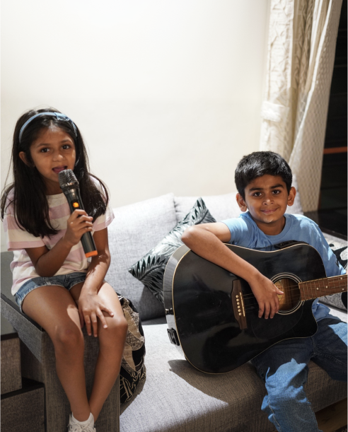 Students with guitar and microphone